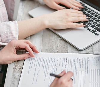 Hands of people filling out a form