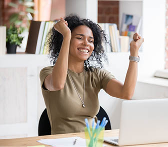 Women holding up arms and smiling